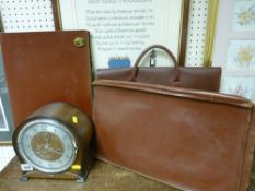 Three vintage attache cases and a polished mantel clock