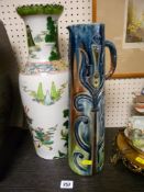Tall Oriental vase depicting warriors, 43 cms high and a Studio pottery tall jug