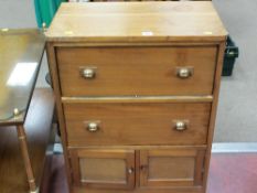 Compact storage unit of two drawers with two small lower base doors