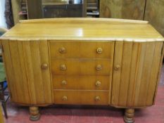 Light wood Art Deco style sideboard with four central drawers flanked by two cupboards with nicely