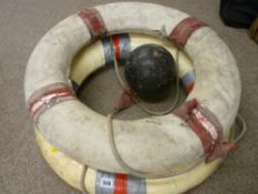 Two vintage life buoys and a plastic nautilus line float
