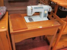 Jones sewing machine in a wooden work table