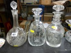 Two Victorian glass decanters and stoppers and a later example for the 1977 Queen Elizabeth Silver