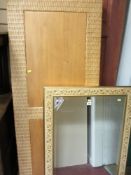 Ornate and gilt framed bevelled edge mirror and a rattan style headboard