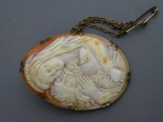 Well carved shell cameo brooch mounted on gilt silver depicting Mary cradling Jesus in her arms, 6.5