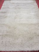 Ivory coloured shaggy style rug, 290 x 200 cms