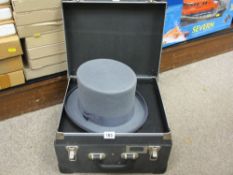 Hard cased hat box with top hat by Wilson & Stafford
