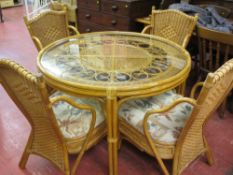 Four matching conservatory woven chairs and circular table