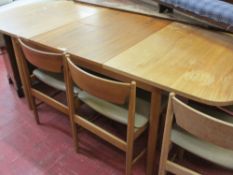 Mid Century dining table with fold-out section and four chairs