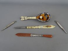 Vintage Goldstone type letter opener, a carved bone example, a miniature tortoiseshell mandolin
