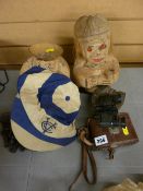 Two carved coconut effigies, a Victorian folding book rack, a sportsman's cap, a pair of Liliput