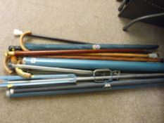 Two tripod cine screens and a bundle of vintage walking sticks and canes