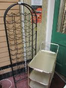 Black metal dome topped wine rack and a brass effect three tier trolley