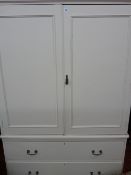 White painted twin door cupboard having two base drawers with drop handles