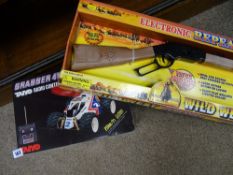 Electronic repeater Wild West toy gun and a Grabber Taiyo radio controlled vehicle in a box