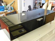 Contemporary black and chrome entertainment unit with fall front cupboard