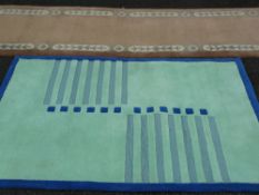 Clarendon mint and cream coloured rug from 'The Mirage' collection, 182 x 120 cms and a tan tassel