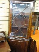 Standing two piece single door glazed corner cabinet with base cupboard