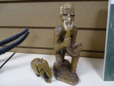Mineral figure of a gentleman smoking a pipe and an elephant