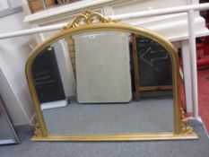 Large gilt framed bevelled edge arch shaped overmantel mirror