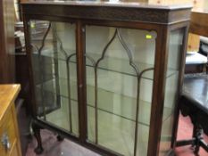 Early 20th Century two door mahogany china cabinet on ball and claw supports