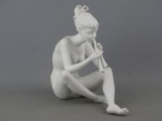 Kaiser German porcelain figure of a seated girl playing panpipes