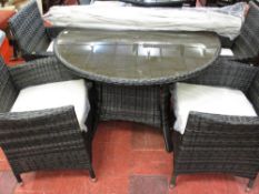 Two tone rattan patio set comprising circular table with glass top and four armchairs with
