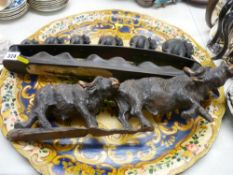 Painted papier mache type tray, a hardwood carving of an elephant train and a pair of carved