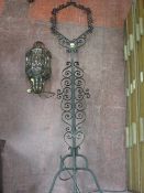 Black wrought iron lamp stand with blown glass shade