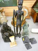 Slate figure of a man sitting on a rock, a wooden figure of an African man and similar items