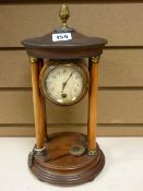 Pendulum mantel clock on pillared supports with drum cased movement