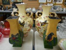 Pair of twin handled floral decorated bulbous vases and another pair of vases