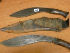 Two vintage kukri knives, one in a sheath