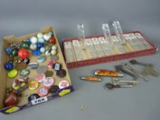 Tray of collectables, marbles, pin badges, penknives and a box of twelve vintage glass knife rests