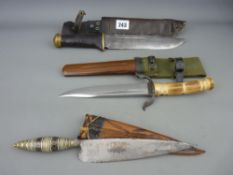 Three military daggers in sheaths including Indonesian, Sea Dayak etc