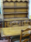 Oak refectory style dining table with four ladderback chairs, similar oak dresser with three shelves