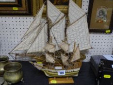 Two model sailing boats on stands