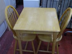 Modern light wood kitchen table and two spindleback chairs