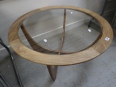 A circular glass topped G-Plan mid-century coffee table