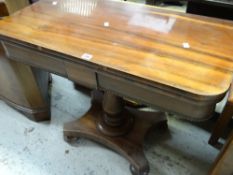 An antique foldover card table