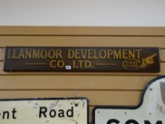A wooden painted sign for Llanmoor Development Company Ltd (first floor)
