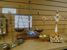 A set of vintage brass balance scales together with a painted floral set and another brass set
