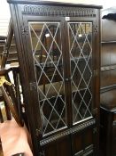 A Priory linenfold Jacobean-style glazed corner cupboard