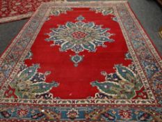 A good large rust ground floral Persian carpet, 340 x 245cms