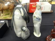 A Lladro model of a penguin and chick together with a Lladro figurine