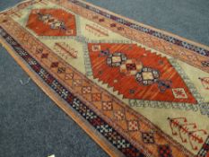 A Turkish woollen geometric patterned runner in blue & orange ground, 2.24m long