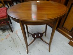 An antique inlaid mahogany two-tier oval occasional table