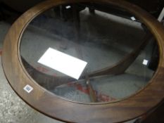 A circular glass topped G-Plan mid-century coffee table