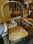 A reproduction elm hoop back Windsor chair