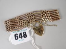 A 9ct yellow gold gate bracelet with tapered ends and attached heart-shaped pad-lock, 24gms Please